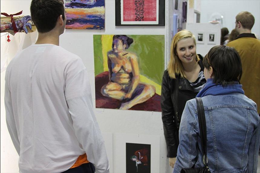 A photo of students inspecting art